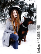Young woman in winter park with dog having fun. Стоковое фото, агентство Ingram Publishing / Фотобанк Лори