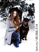 Young woman in winter park with dog having fun. Стоковое фото, агентство Ingram Publishing / Фотобанк Лори