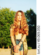 Fashion portrait of beautiful hippie young woman wearing boho chic clothes, chiffon cardigan and boho chic style bijouterie. Blonde haired woman dressed in bohemian style at the beach. Стоковое фото, агентство Ingram Publishing / Фотобанк Лори