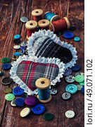 Accessories for home crafts.  button and spools of thread for needlework on bright background. Стоковое фото, агентство Ingram Publishing / Фотобанк Лори