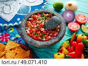 Pico de Gallo sauce from Mexico with tomato cilantro and onion in molcajete. Стоковое фото, агентство Ingram Publishing / Фотобанк Лори