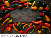 Mexican hot chili peppers colorful mix habanero poblano serrano jalapeno on wood. Стоковое фото, агентство Ingram Publishing / Фотобанк Лори