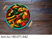 Mexican hot chili peppers colorful mix habanero poblano serrano jalapeno on wood. Стоковое фото, агентство Ingram Publishing / Фотобанк Лори