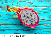 Pitaya dragon fruit cutted in pink and green background. Стоковое фото, агентство Ingram Publishing / Фотобанк Лори