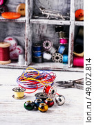 Beads,thread and bobbins for needlework.Picture in light key. Стоковое фото, агентство Ingram Publishing / Фотобанк Лори