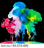 Colored ink drops in water on black background, flipped over view. Стоковое фото, агентство Ingram Publishing / Фотобанк Лори
