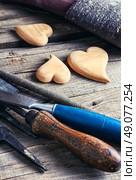 Symbolic wooden hearts cut by hand and carpenter tools. Set woodworking tool. Стоковое фото, агентство Ingram Publishing / Фотобанк Лори