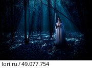 Young elven girl with sword at night forest. Стоковое фото, агентство Ingram Publishing / Фотобанк Лори