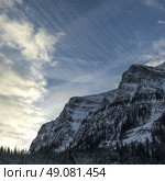 Cloud streaked sky over mountain top, Lake Louise, Banff National Park, Alberta, Canada. Стоковое фото, агентство Ingram Publishing / Фотобанк Лори