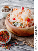 Sauerkraut and spices on wooden background in rustic style. Sauerkraut with cranberries. Стоковое фото, агентство Ingram Publishing / Фотобанк Лори