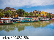 Vietnamese boats on the Thu Bon River in Hoi An Old town in Vietnam in summer. Vietnam, Hoi An - December 1, 2024. Редакционное фото, фотограф Корчагина Анастасия / Фотобанк Лори