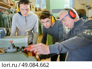 Senior carpenter with two learners. Стоковое фото, агентство Ingram Publishing / Фотобанк Лори