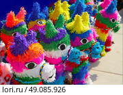 Mexican party pinatas decorated with fringed tissue colorful paper. Стоковое фото, агентство Ingram Publishing / Фотобанк Лори