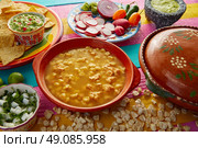 Green Pozole verde with blanco mote corn and ingredients on colorful table. Стоковое фото, агентство Ingram Publishing / Фотобанк Лори
