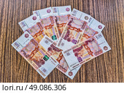 Russian money - paper bills of 5000 rubles - are lying on the table. Стоковое фото, фотограф Владимир Устенко / Фотобанк Лори