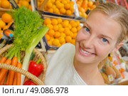 Woman showing basket of vegetables. Стоковое фото, агентство Ingram Publishing / Фотобанк Лори