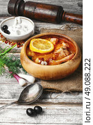 National Ukrainian soup Solyanka. Traditional solyanka with smoked meats in wooden plate. Стоковое фото, агентство Ingram Publishing / Фотобанк Лори