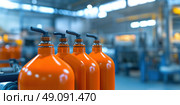 Orange gas tanks. Bundle of gas cylinder and high pressure gauges, meter, valve. Many argon cylinders with compressed oxygen for industry, welding. Fuel manufacturing. Liquefied gas production factory. Стоковое AI-изображение, AI-художник Марина Демидюк / Фотобанк Лори