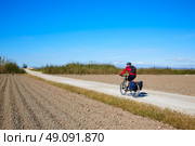 Biker MTB cycle tourism with panniers in Albufera of valencia spain. Стоковое фото, агентство Ingram Publishing / Фотобанк Лори