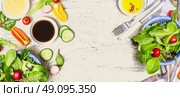 Tasty salad making with vegetables and dressing ingredients on  light rustic background, top view, banner. Healthy  lifestyle or detox diet food  concept. Стоковое фото, агентство Ingram Publishing / Фотобанк Лори