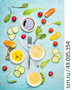 Salad dressing ingredients: vinegar ,mustard,oil and honey with vegetables. Cutlery with salad ingredients, top view. Flat lay of healthy  lifestyle or detox diet food  concept, Стоковое фото, агентство Ingram Publishing / Фотобанк Лори