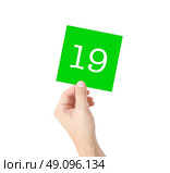 19 written on a card held by a hand. Стоковое фото, агентство Ingram Publishing / Фотобанк Лори