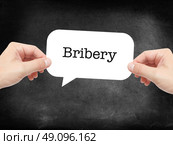 Bribery written on a speechbubble. Стоковое фото, агентство Ingram Publishing / Фотобанк Лори