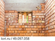 house under constraction with modern brick walls and holes for doors and windows. Стоковое фото, фотограф Feruza Tashmetova / Фотобанк Лори