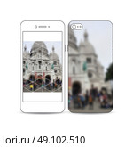 Mobile smartphone with an example of the screen and cover design isolated on white background. Blurred image, view of cathedral Sakre-Ker, Paris cityscape, modern vector texture. Стоковая иллюстрация, агентство Ingram Publishing / Фотобанк Лори