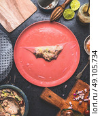 Homemade summer rolls with canned tuna fish filling, step by step wrapping on rustic kitchen table with plates, tolls and ingredients, top view. Стоковое фото, агентство Ingram Publishing / Фотобанк Лори