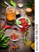 Herbs and spices selection with colorful peppercorns and dry chili on rustic wooden background, close up. Стоковое фото, агентство Ingram Publishing / Фотобанк Лори