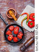 Sun-dried tomatoes in the pan. Spicy dish with sun-dried tomatoes and hot spices. Стоковое фото, агентство Ingram Publishing / Фотобанк Лори