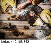 raw Handmade ravioli Triangoli on rustic wooden background, top view. Стоковое фото, агентство Ingram Publishing / Фотобанк Лори