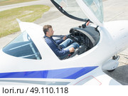 Downward view of man in cockpit of aircraft. Стоковое фото, агентство Ingram Publishing / Фотобанк Лори