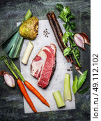 Raw beef brisket meat with organic vegetables ingredients for soup or broth cooking on rustic background, top view. Стоковое фото, агентство Ingram Publishing / Фотобанк Лори