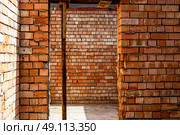 house under constraction with modern brick walls and holes for doors and windows. Стоковое фото, фотограф Feruza Tashmetova / Фотобанк Лори