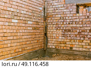 house under constraction with modern brick walls and holes for doors and windows. Стоковое фото, фотограф Feruza Tashmetova / Фотобанк Лори
