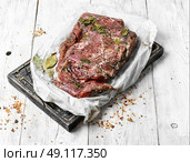 meat prepared for jerky. raw meat in spicy spices and seasonings on the kitchen board. Стоковое фото, агентство Ingram Publishing / Фотобанк Лори