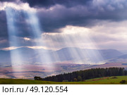 Sunlight beams over clouds in Tatra mountains. Rays in cloudy sky. Стоковое фото, агентство Ingram Publishing / Фотобанк Лори