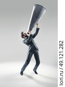 Elegant manager yelling over the huge megaphone. Стоковое фото, агентство Ingram Publishing / Фотобанк Лори
