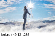 Conceptual picture of young businessman achieving a success. Стоковое фото, агентство Ingram Publishing / Фотобанк Лори