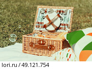 Picnic Basket Food On White Blanket With Pillows And Soap Bubbles. Стоковое фото, агентство Ingram Publishing / Фотобанк Лори