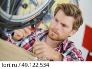 professional repairer fixing bike. Стоковое фото, агентство Ingram Publishing / Фотобанк Лори