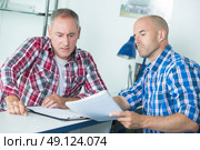 serious upset worried men sitting with business papers. Стоковое фото, агентство Ingram Publishing / Фотобанк Лори