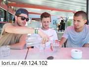 three happy friends drink water to quench their thirst. Стоковое фото, агентство Ingram Publishing / Фотобанк Лори