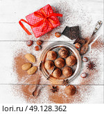 Chocolate truffles candy. Chocolate truffles with cocoa and nuts and red box with gift. Стоковое фото, агентство Ingram Publishing / Фотобанк Лори