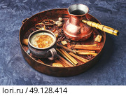 set of coffee ingredients. cezve and cup of coffee in copper tray with oriental spices. Стоковое фото, агентство Ingram Publishing / Фотобанк Лори