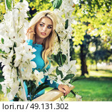 Amazing blond nymph swings on the ornate seesaw. Стоковое фото, агентство Ingram Publishing / Фотобанк Лори