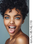 A woman with curly hair and blue eyes is contorting her face in a humorous expression. Стоковое AI-изображение, AI-художник Данила Большаков / Фотобанк Лори