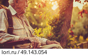 An elderly man is seated in a wheelchair, looking straight ahead. Стоковое AI-изображение, AI-художник Данила Большаков / Фотобанк Лори